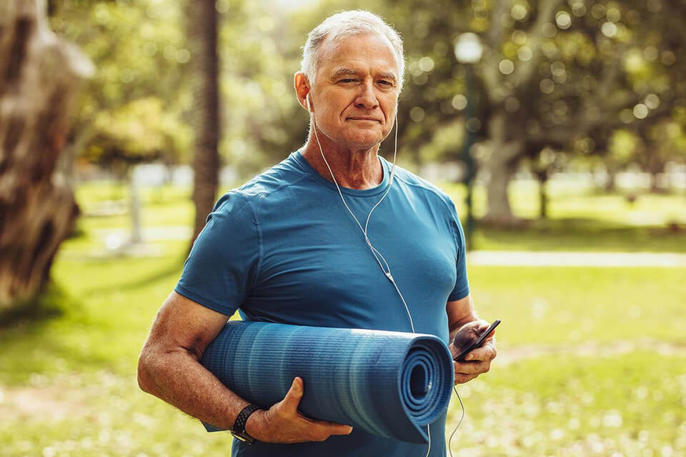 Mature man with yoga mat